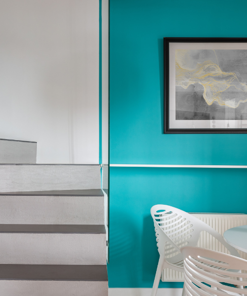 A chair and table in a room with blue walls